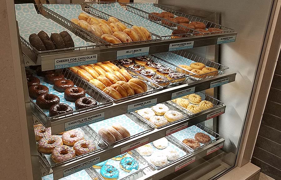 Doughnuts behind display glass