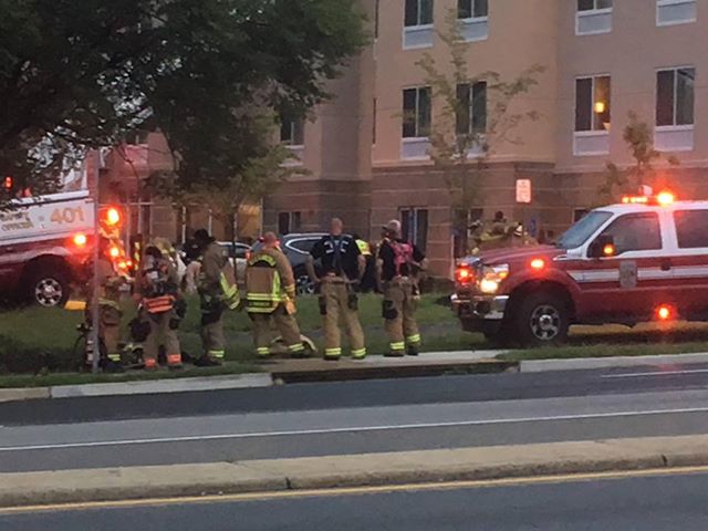 firefighters gathered outside of building