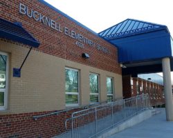 The front of Bucknell Elementary, with letters spelling out name of school visible on bricks next to awning over main entrance