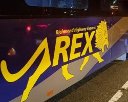 Side of a REX bus showing logo