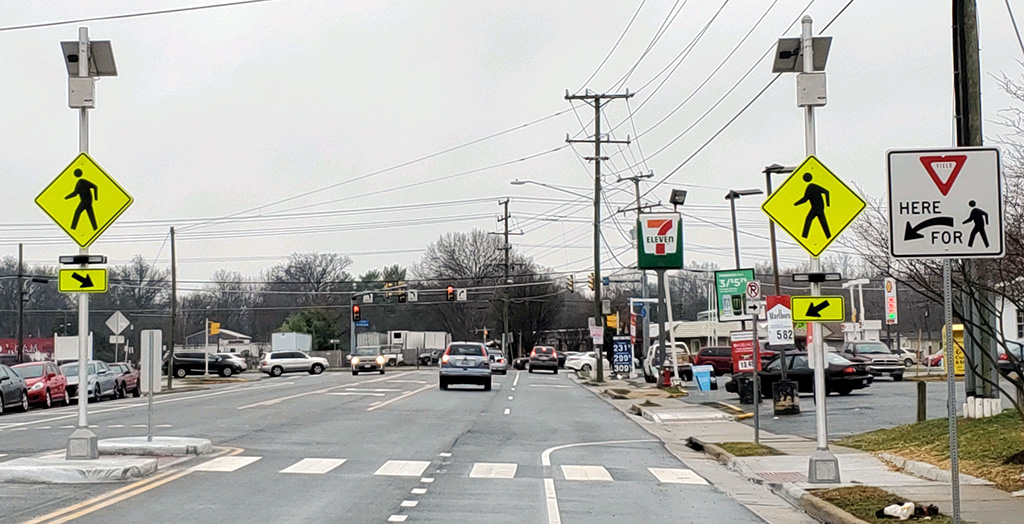 View of new crosswalk with lights and signs visible
