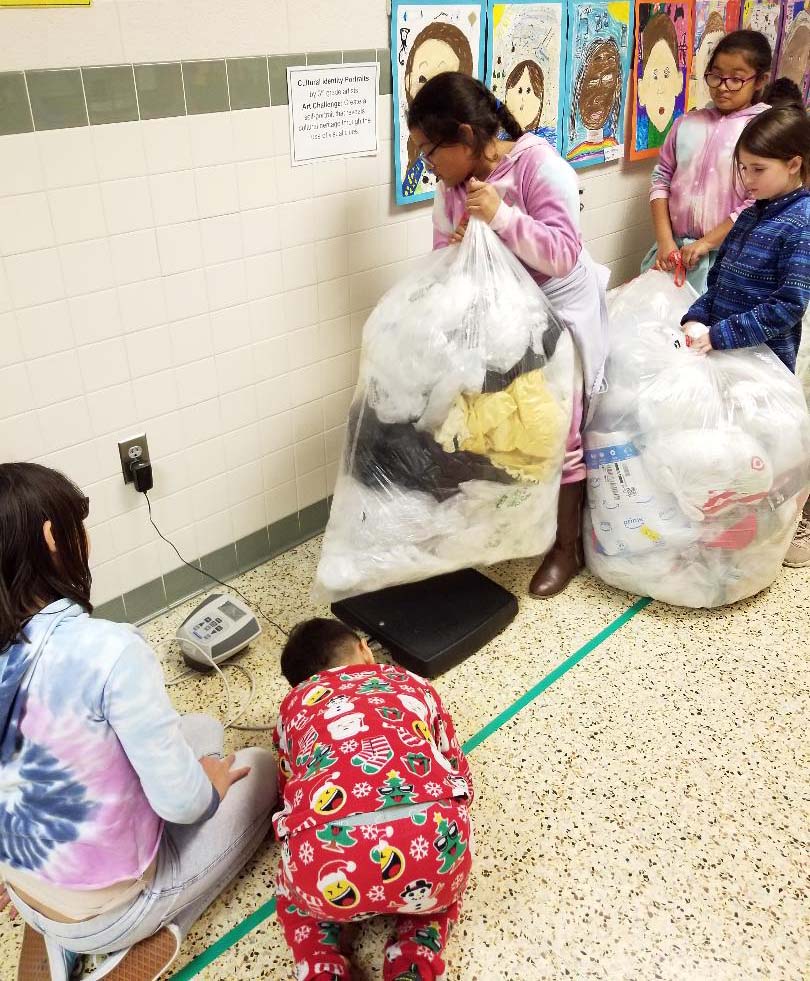 Fort Hunt students prepare to weigh backs of recycling material