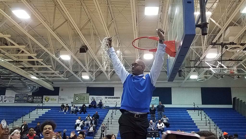 Houston holding net with arms raised