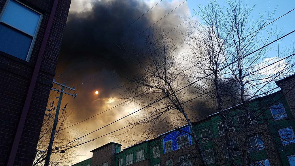 Clouds over the sun between two buildings