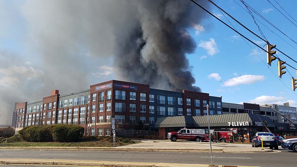 Building with huge smoke behind it