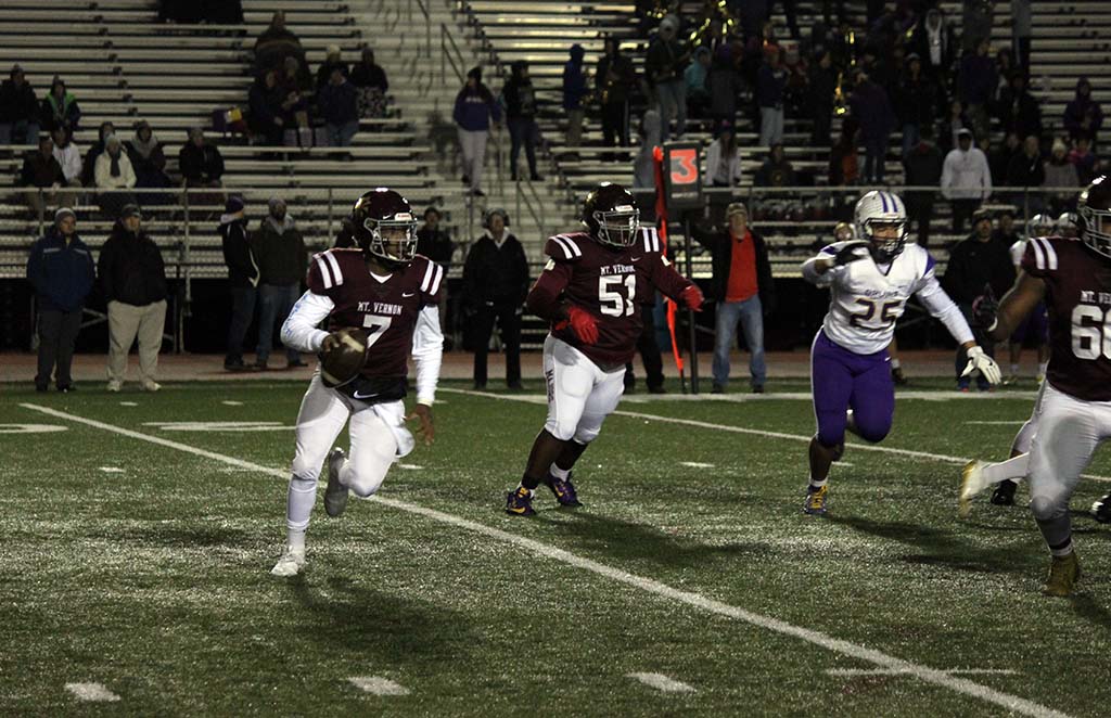 Webb running with ball with a lineman in the background