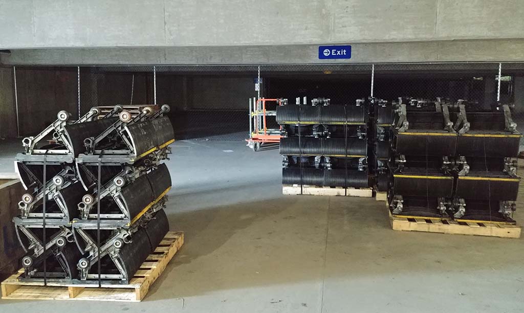 Escalator parts stacked in garage