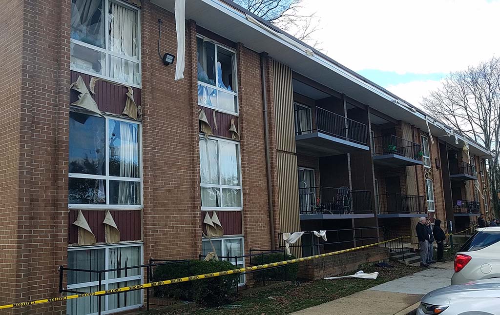 Broken windows and pieces of the building hanging down