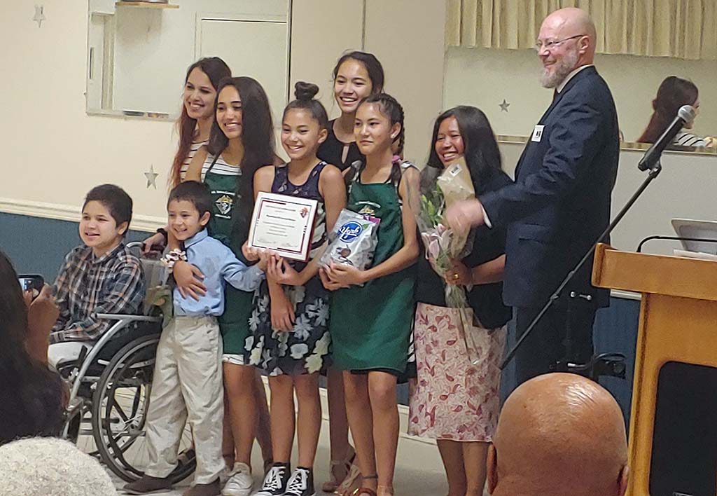 Family posing with award