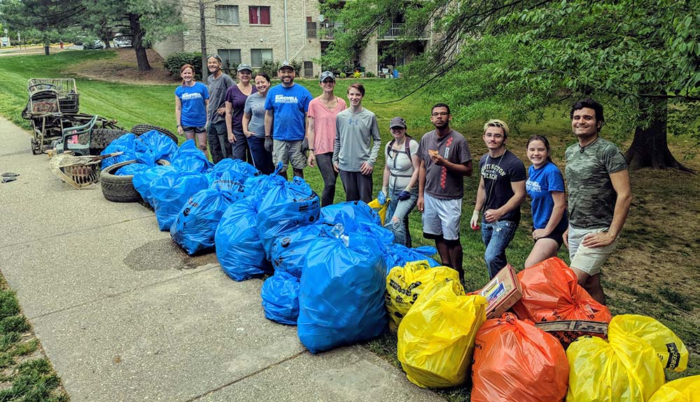 People standing in front of trash bags