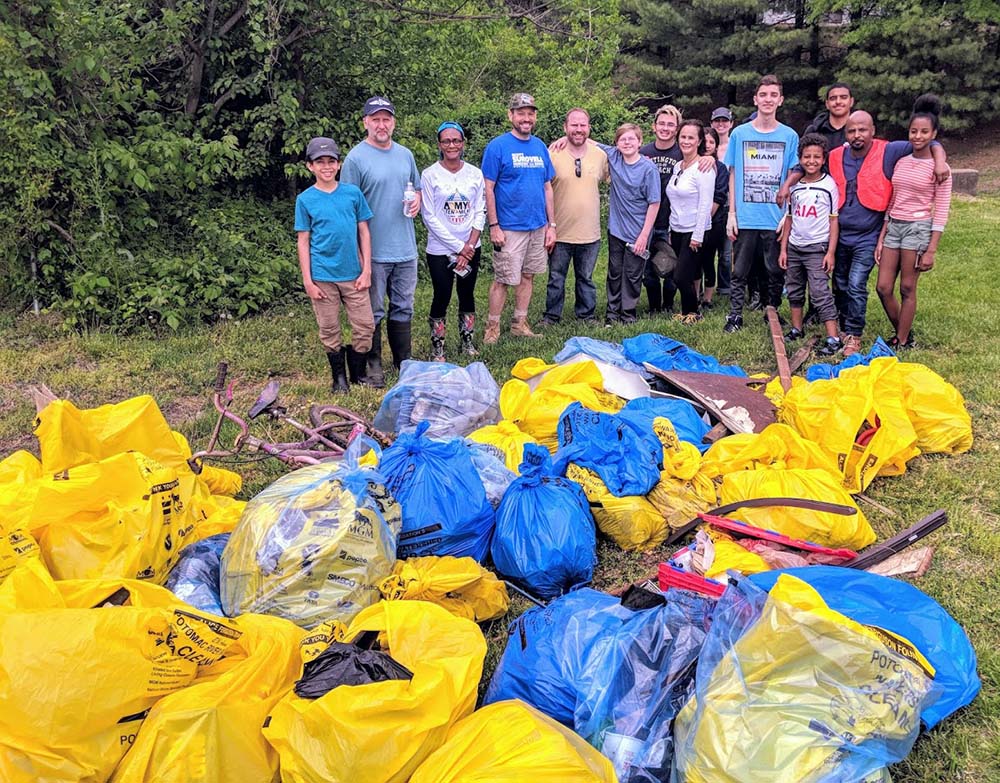 People standing in front of trash bags