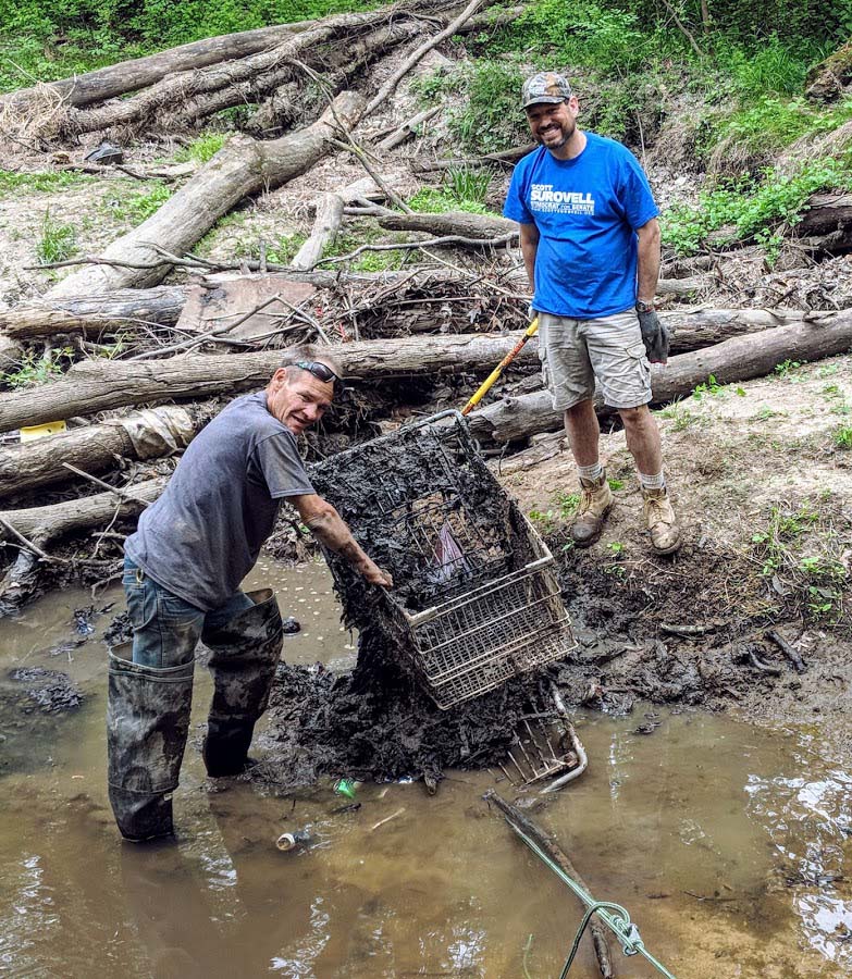 Surovell and volunteer removing cart